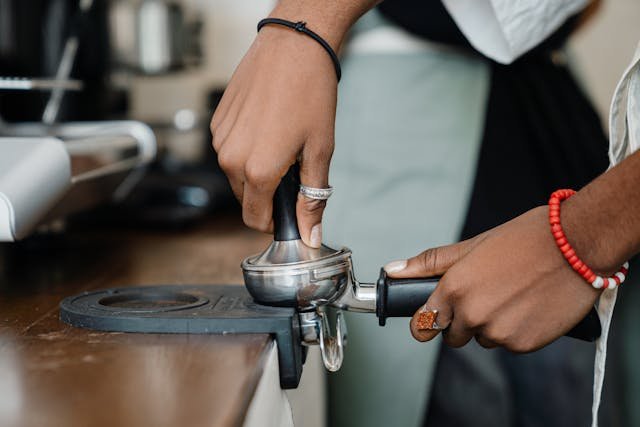 Baristas working with modern equipment